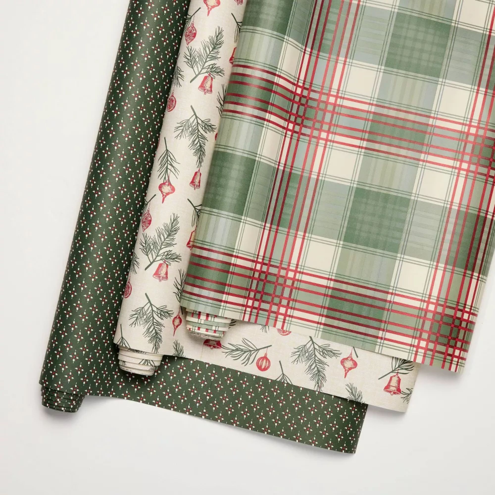 Set of green floral, red and green plaid, and holly motif gift wrap