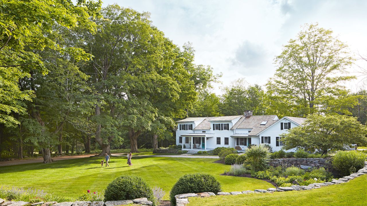  exterior of white country house with lawn 