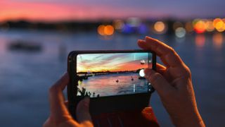 best camera phone - close-up of smartphone being used to photograph a night scene