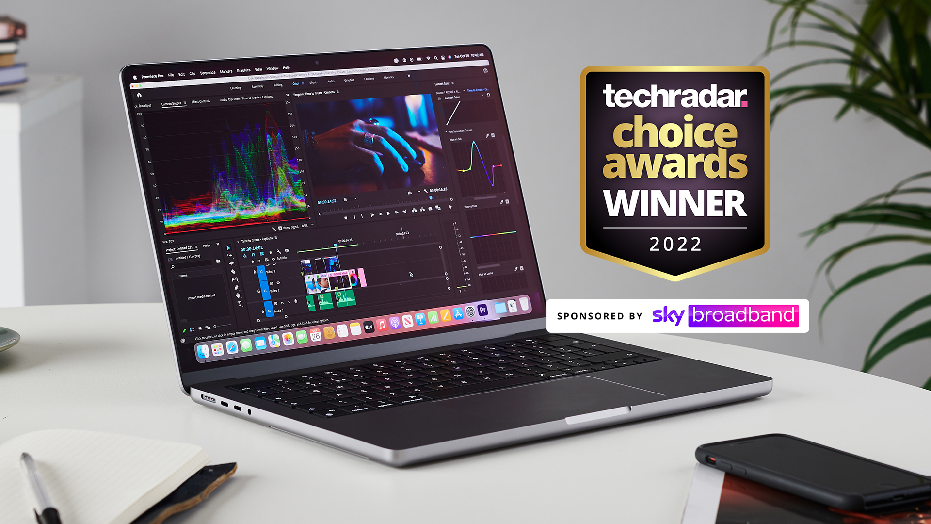 MacBook Pro 14 on desk with award-winning logo