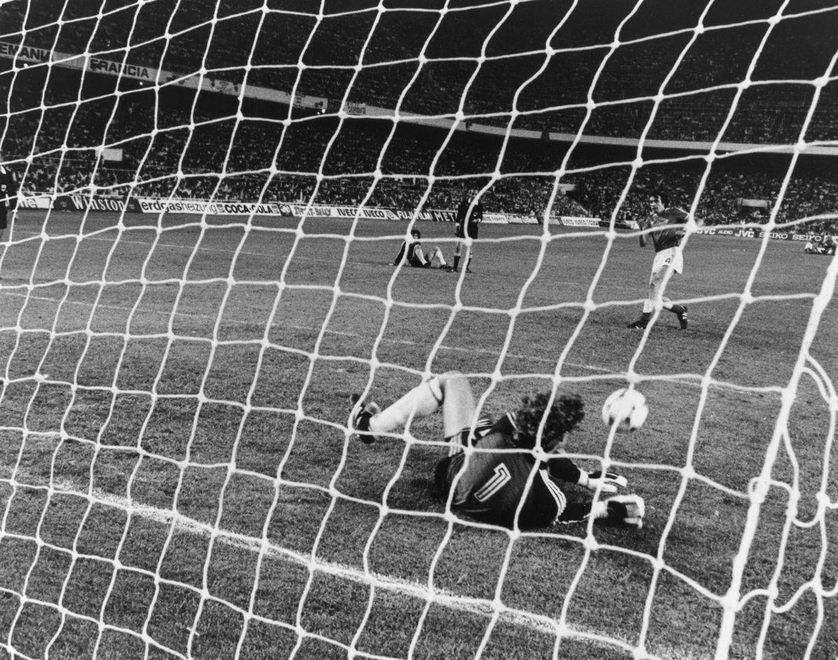 West Germany goalkeeper Harald Schumacher saves a penalty from France's Maxime Bossis during the shootout in the 1982 World Cup semi-final