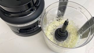 The KitchenAid KFP1319 food processor having just be used to chop onions