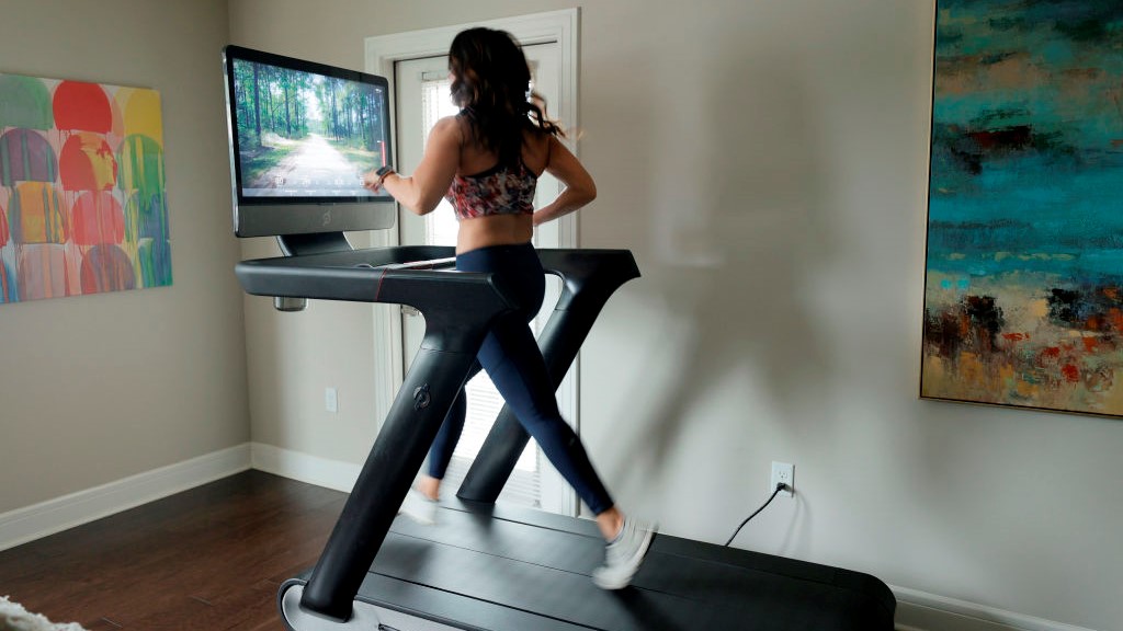 a photo of a woman running on the Peloton tread