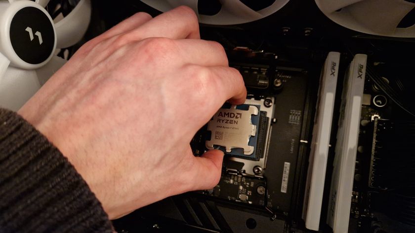 A AMD Ryzen 7 8700G being put into it&#039;s socket by a reviewer