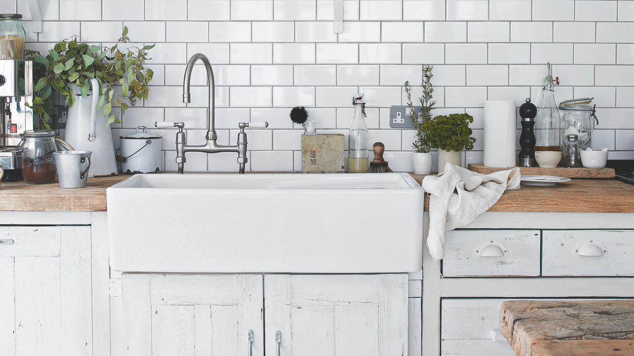 White Belfast sink with silver taps in a rustic kitchen