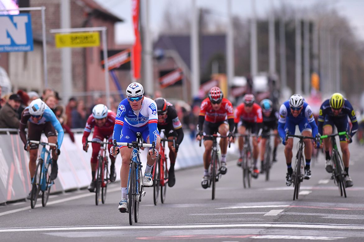 Arnaud D&eacute;mare leads the main bunch across the line at Kuurne-Brussel-Kuurne.