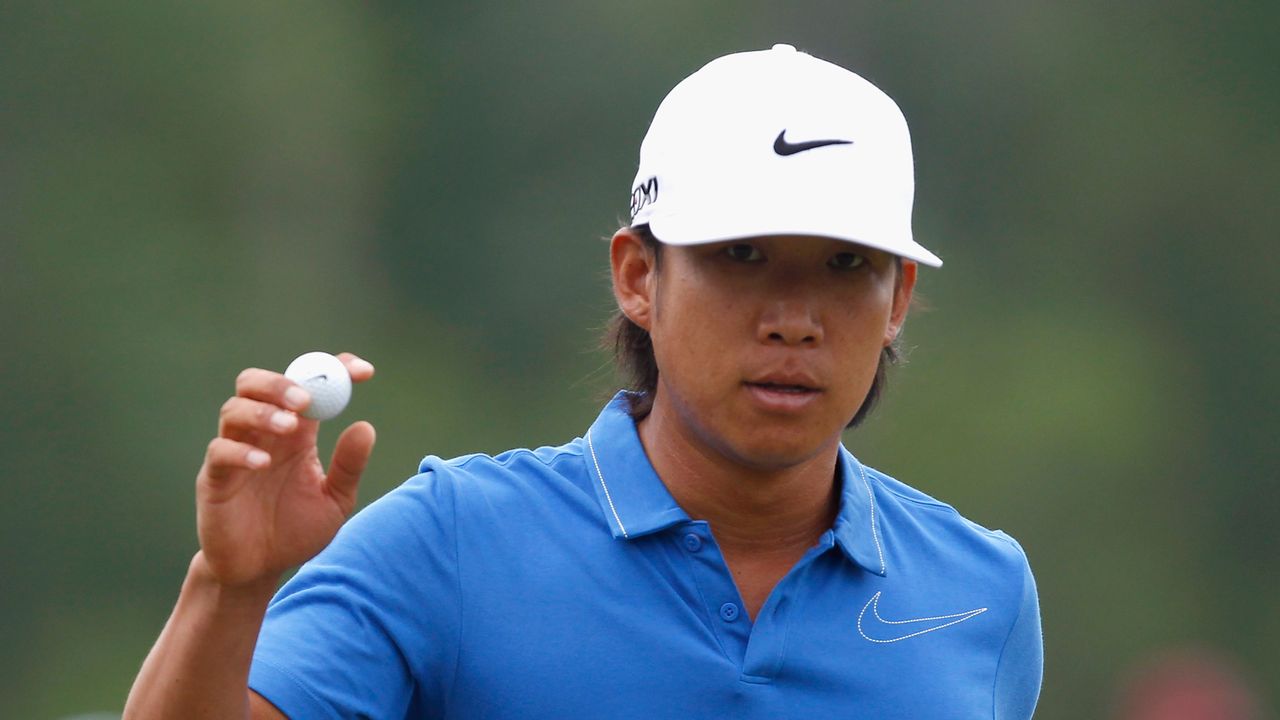 Anthony Kim waves to the gallery after making a par on the second hole during the first round of the Shell Houston Open in 2012