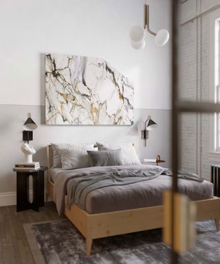 Small neutral bedroom space with contrast of white walls with gray bedding and marbled wall art