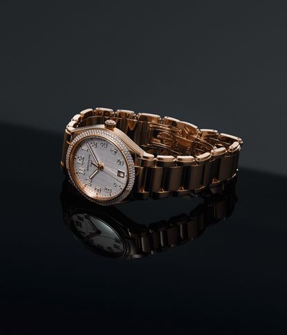 Rose gold patek philippe watch on a dark background