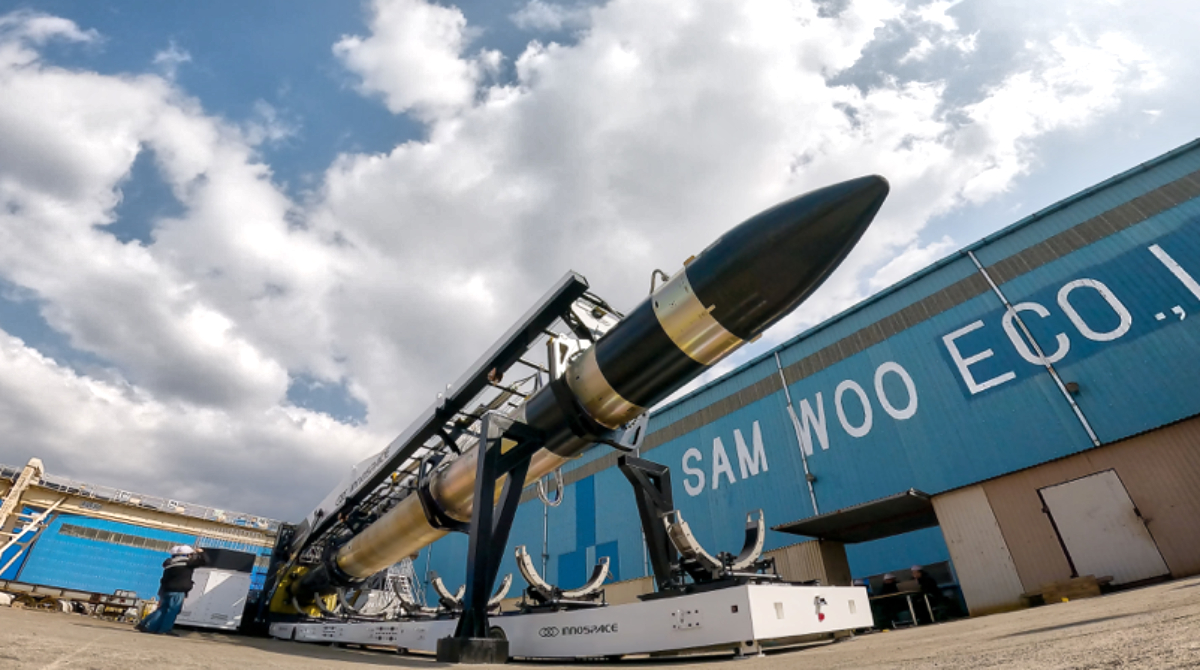 A black and chrome rocket lays horizontal.