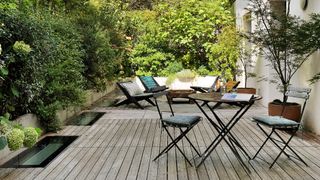 Modern garden furniture idea with bistro table and seating around fire pit