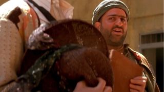 Omid Djalili stands speaking confidently in a prison setting in The Mummy.