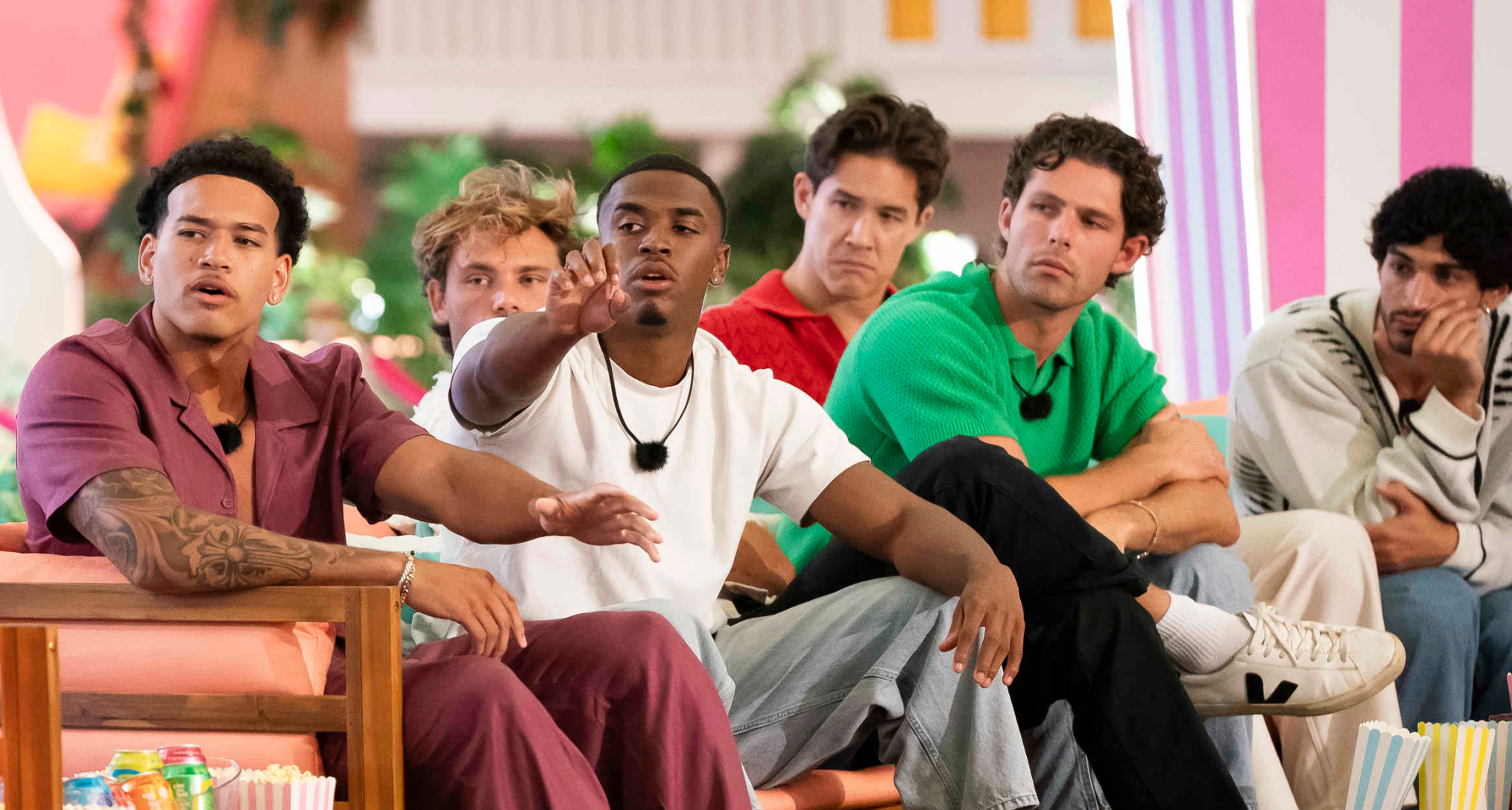 Corbin Mims, Gal Tshnieder, Kuman "KC" Dameon Chandler, Carl Schmidt, Dylan Wrona, and Zacharias Georgiou look shocked sitting on a couch together during movie night on love island usa season 8