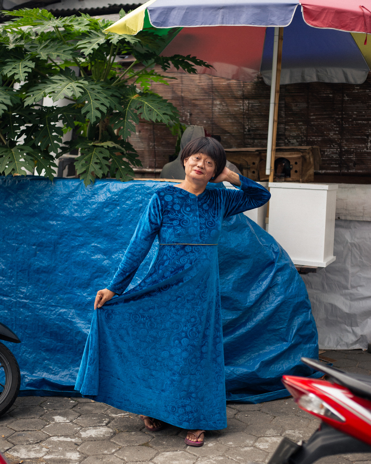 Rini (56) stands in the front yard of Pondok Pesantren Al-Fatah, a Quranic school for trans women. Rini earns her income as a street musician and regularly attends Pondok Pesantren Al-Fatah to study the Quran and pray with friends from the queer community