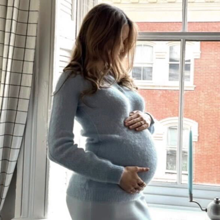 Photo of Elizabeth Grace Hand wearing her maternity dress for baby shower party.