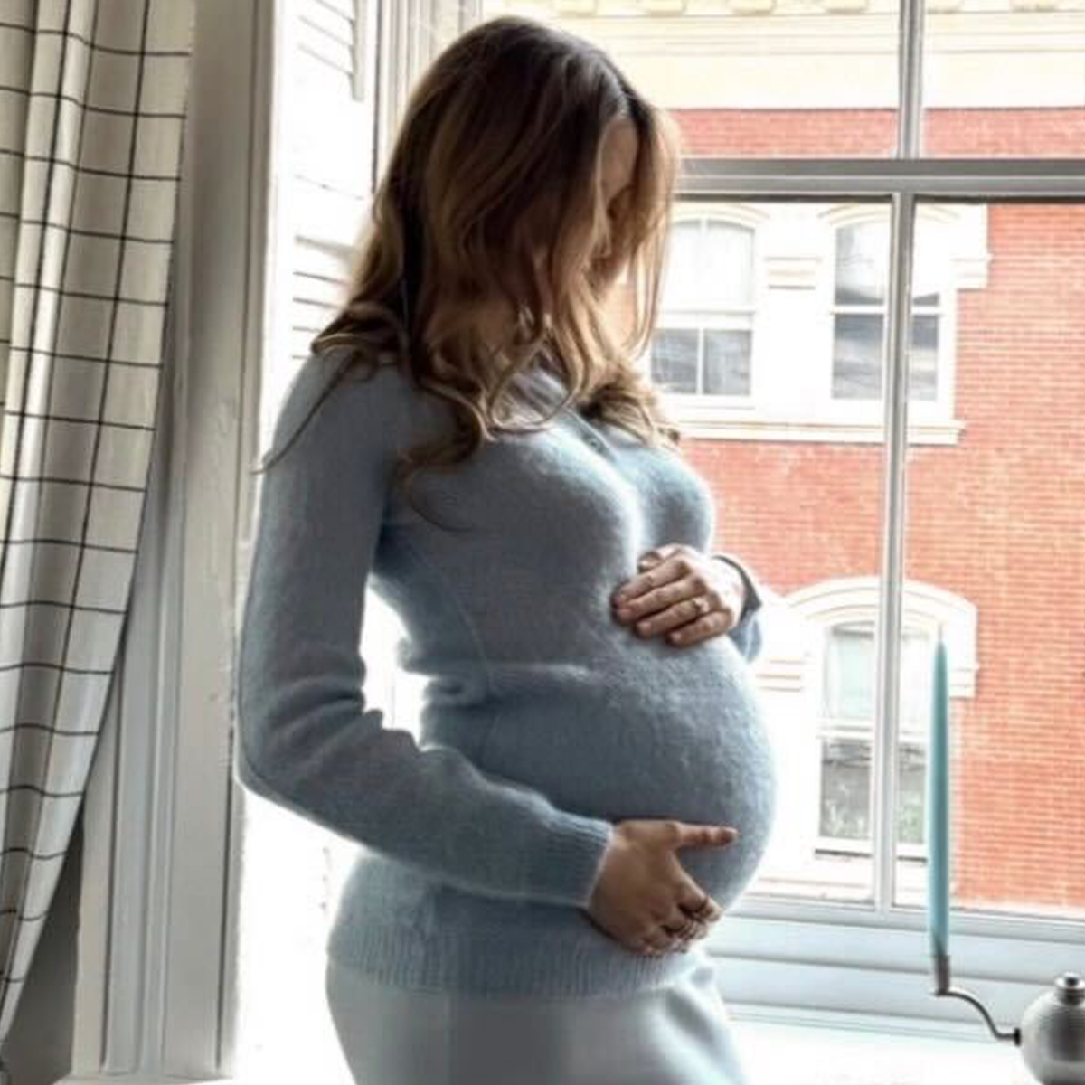 Photo of Elizabeth Grace Hand wearing her maternity dress for baby shower party.