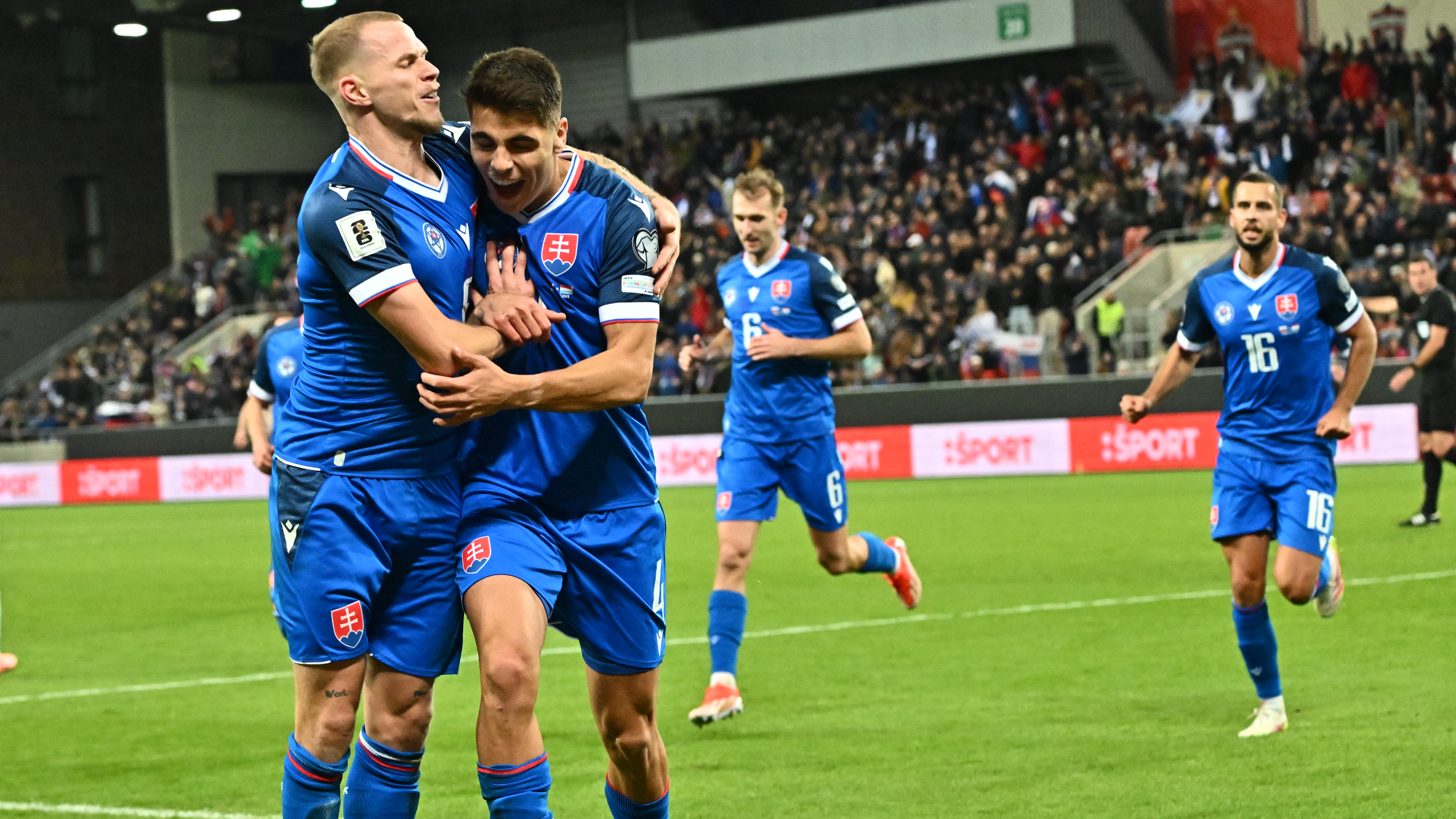 Slovakia's defender #04 Adam Obert (2nd L) celebrates with Slovakia's midfielder #08 Ondrej Duda after scoring the 1-0 goal during the 2026 World Cup qualifying group A football match between Slovakia and Luxembourg