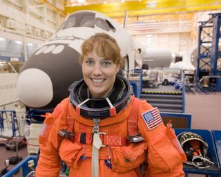 NASA astronaut Dorothy Metcalf-Lindenburger poses for a photo in the Space Vehicle Mock-up Facility at NASA's Johnson Space Center.