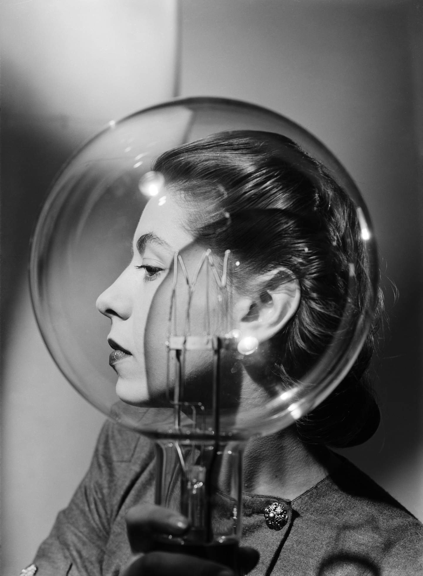 Lee Miller, Model with lightbulb, Vogue Studio, London, England c.1943&amp;copy; Lee Miller Archives, England 2024. All rights reserved. leemiller.co.uk