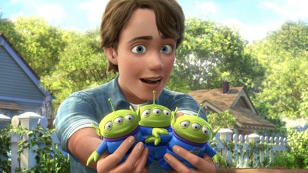 Andy with the three aliens at the end of Toy Story 3