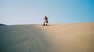 Woman sandboarding in Peru