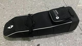 Motocaddy Flightsafe Travel Cover resting on the floor of an airport departure lounge.