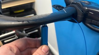 Internal cable routing tool in use on mountain bike