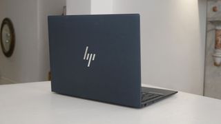 HP Elite Dragonfly G3 laptop on a white table.
