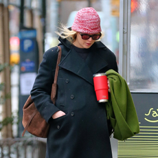 Jennifer Lawrence walks in New York City wearing a blue wool coat and Liffner bag