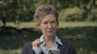 Bridget at the park with her phone in Bridget Jones: Mad About The Boy