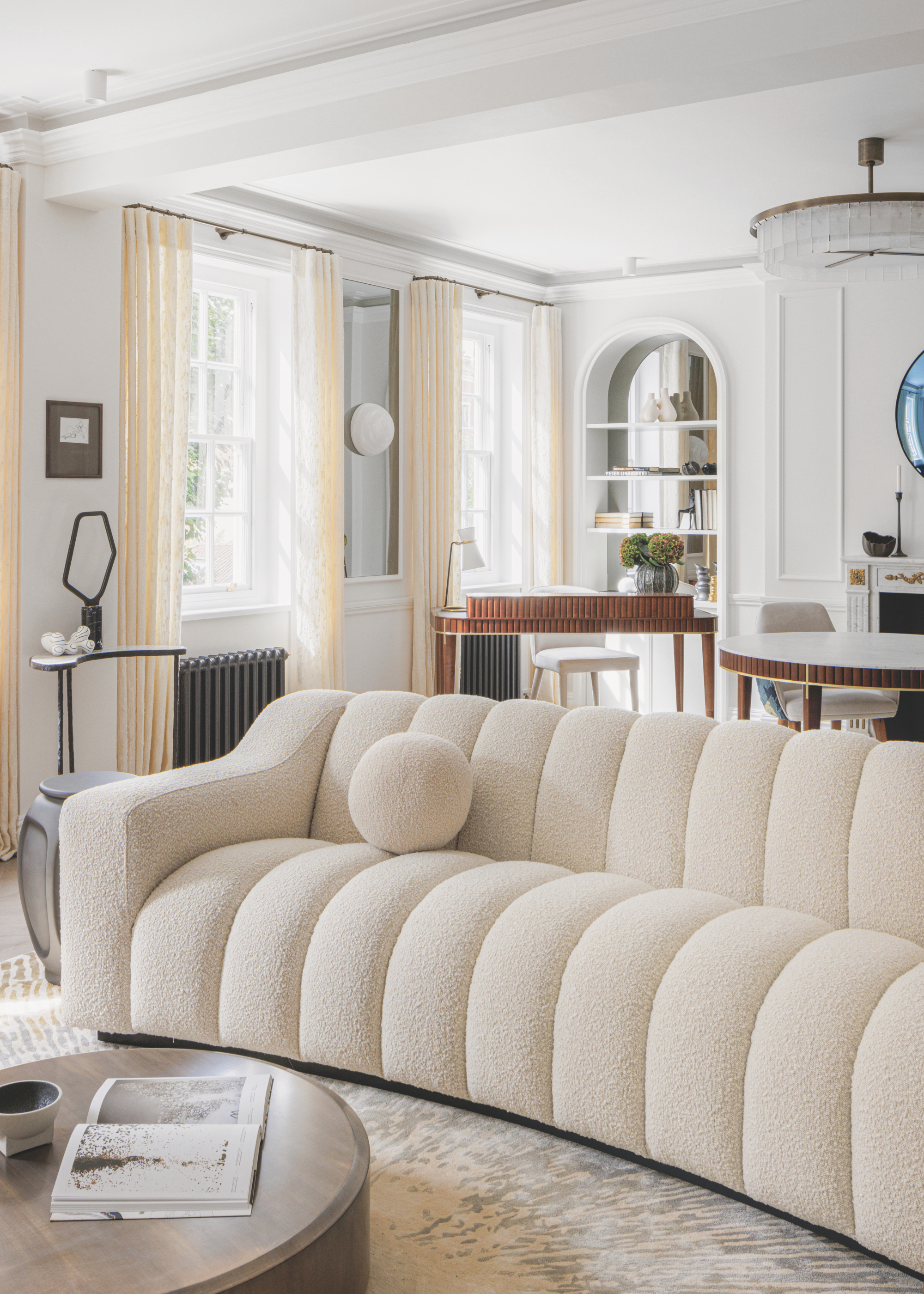 A large cream statement sofa in a white living space.