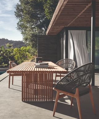 teak outdoor table and chairs on a deck