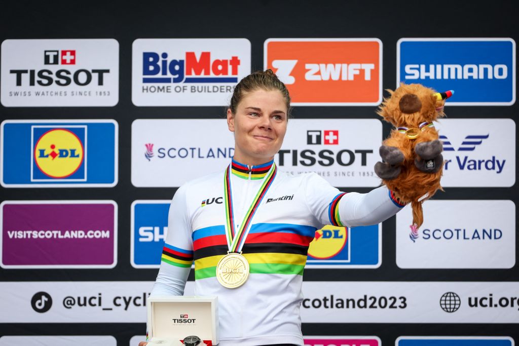 Lotte Kopecky celebrates on the podium after winning the elite women's road race at the 2023 Road World Championships in Glasgow