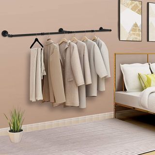 Black mounted clothes rack in bedroom