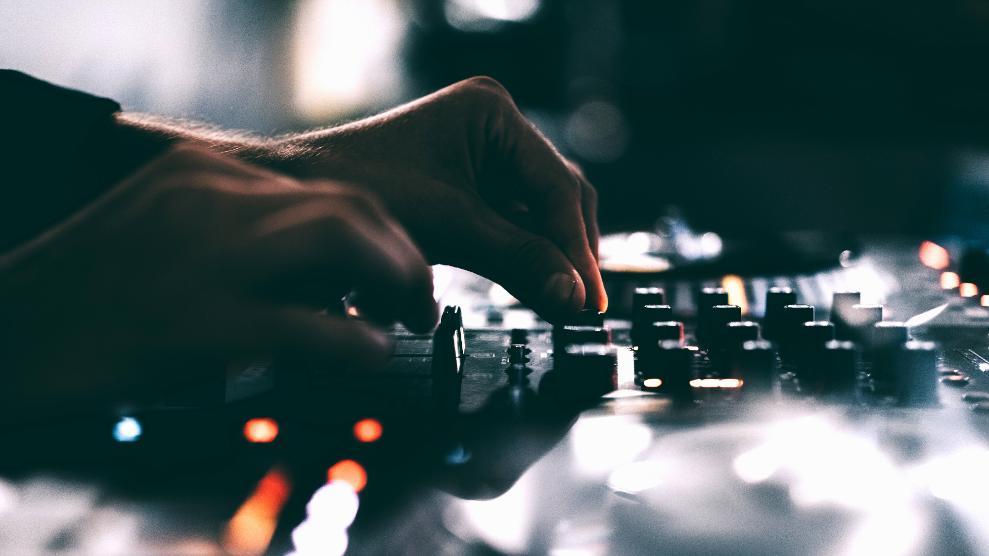 A closeup of a hand adjusting knobs