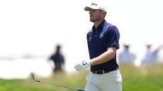 Matt Vogt walking holding a club during a practice round at the 2025 US Open