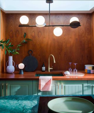 copper splashback and worktop in kitchen