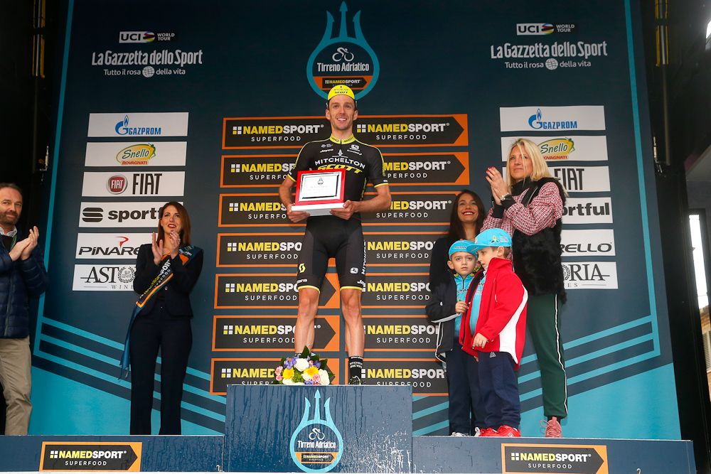 Adam Yates on the stage 5 podium at Tirreno-Adriatico with Michele Scarponi's family