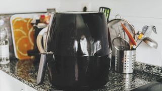 An air fryer sat on a worktop to illustrate What you need to know before buying an air fryer