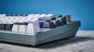 A photo of the Keychron Q1 Pro in gray aluminum with white, black and purple keycaps.