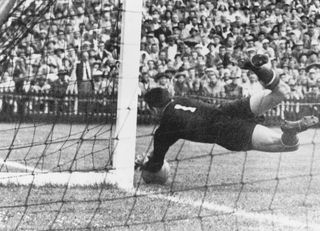 Hungarian goalkeeper Gyula Grosics makes a save during a World Cup quarterfinal against Brazil at the Wankdorf Stadium, Berne, Switzerland, 27th June 1954. Hungary won the match 4-2.