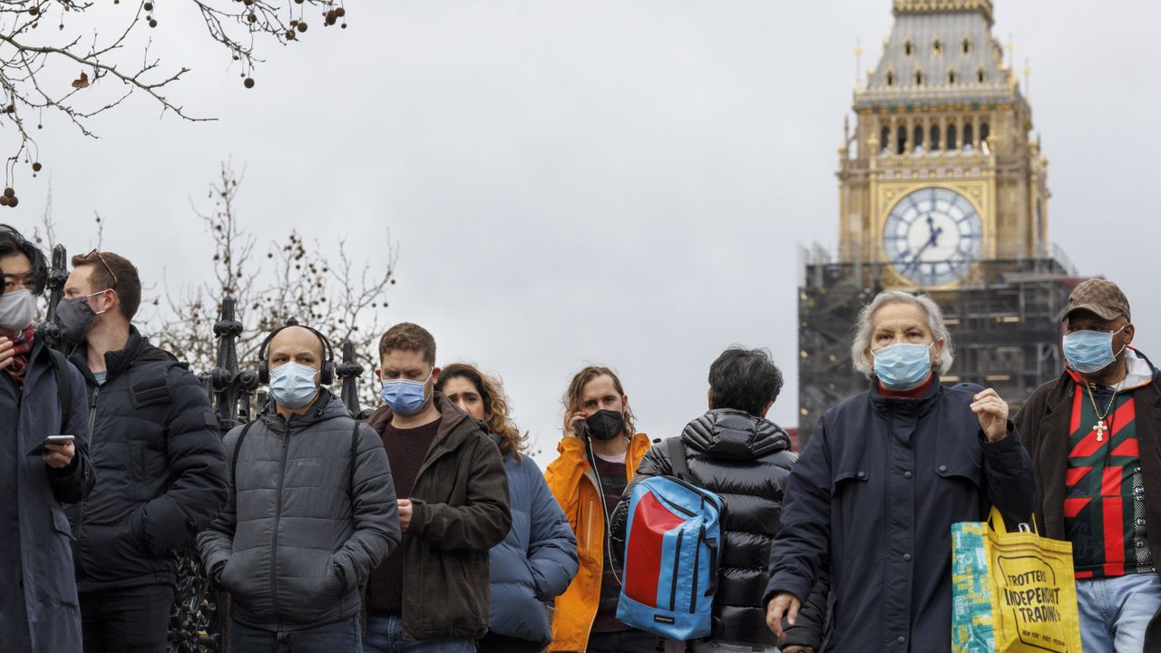 People queue for a booster vaccine outside St Thomas&amp;#039; Hospital, London