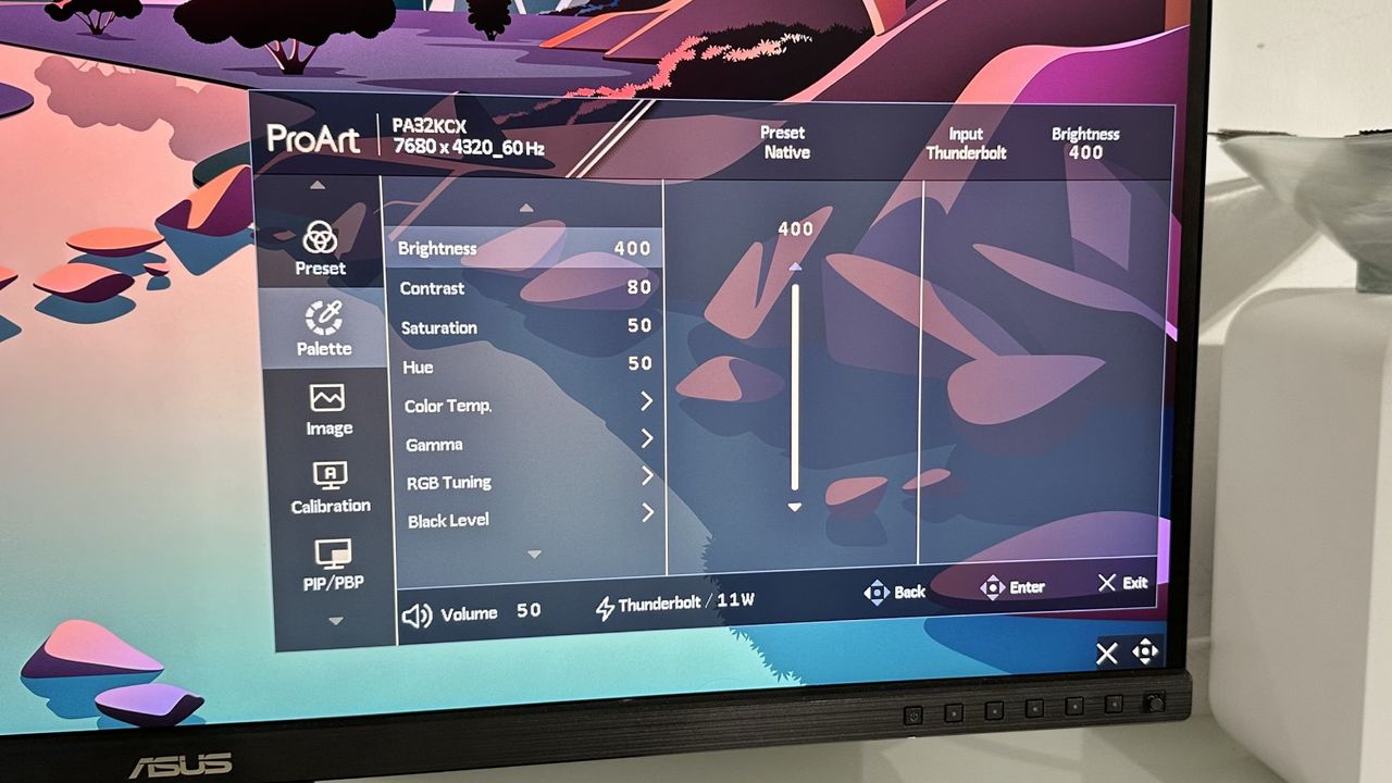 The Asus ProArt PA32KCX 8K monitor on a white desk in a home office during our review process