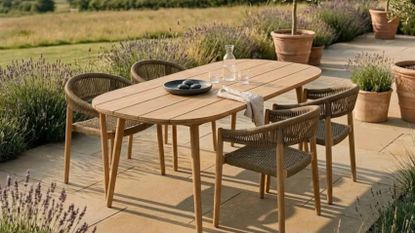 an outdoor table on a patio surrounded by lavender plants