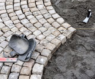 stone cobble paving being laid for a garden path