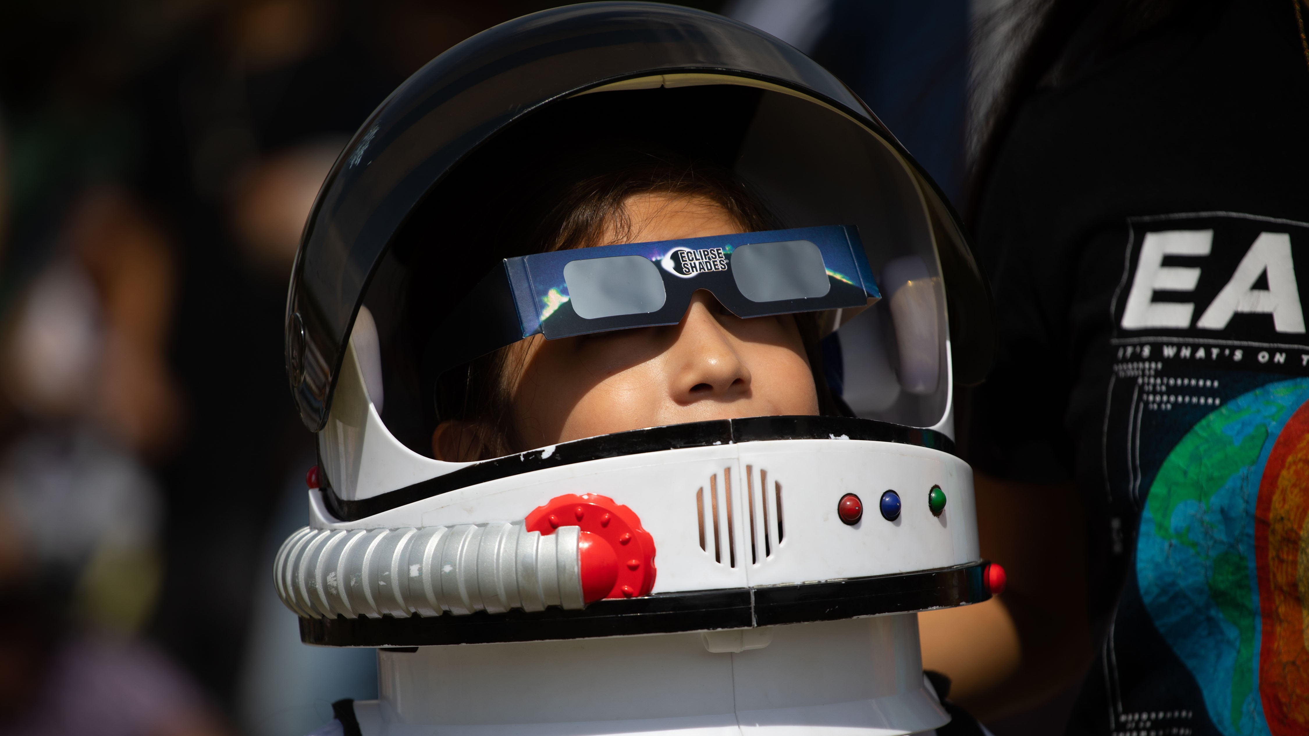A child wearing an astronaut costume observes the Annular Solar Eclipse with using safety glasses at the facilities of the National Autonomous University of Mexico (UNAM) in Mexico City, Mexico on October 14, 2023