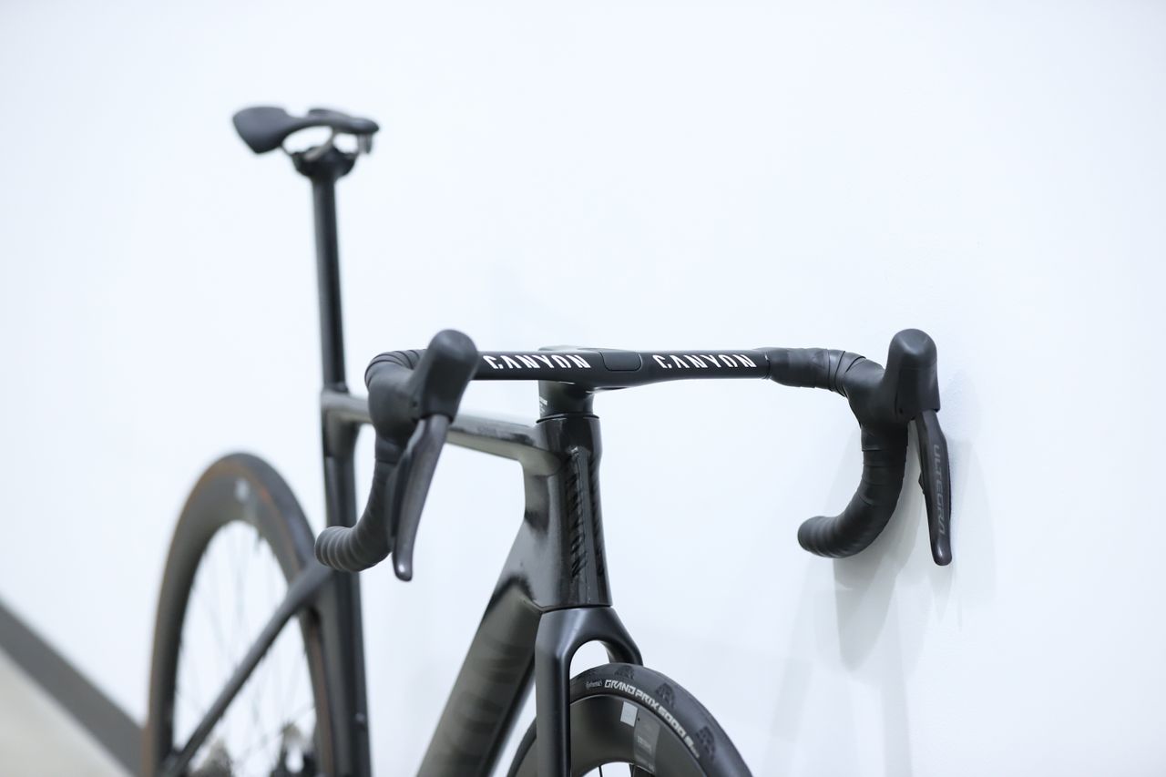 A Black Canyon Aeroad CFR stands against a white wall