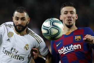 Real Madrid’s Karim Benzema, and Barcelona’s Clement Lenglet fight for the ball