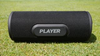 Blue Tees Player Magnetic Speaker resting on the green