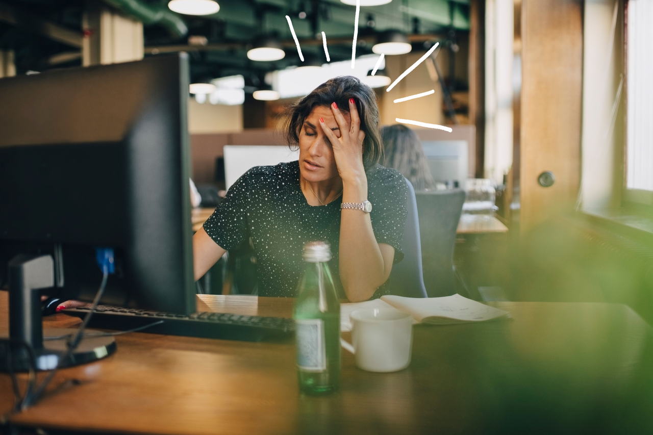 Woman with headache to illustrate should you go to work with a cold